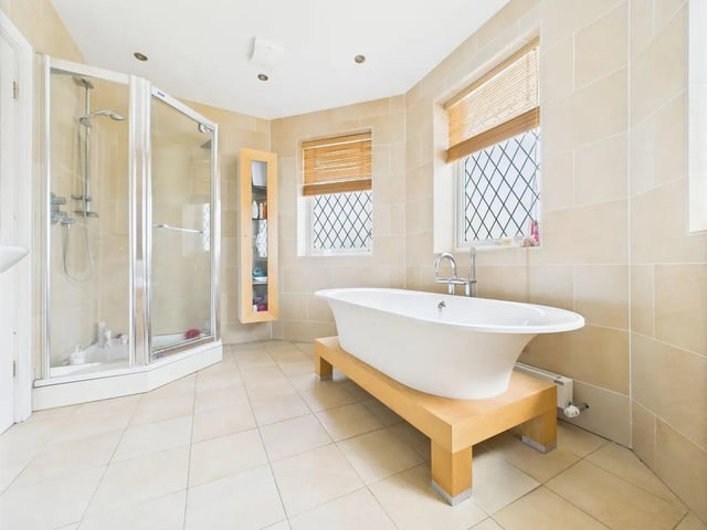 One of two family bathrooms offering both practicality and opulence featuring a roll-top bath and separate shower cubicle