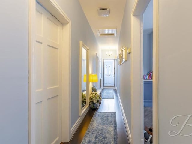 The narrow entrance hall runs the length of the Mansfield bungalow, with a storage cupboard at the far end and access to all the main rooms of the property.