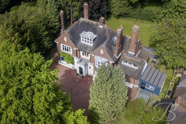 Before we step inside the Norfolk Drive mansion, let's take a look at an aerial shot from a drone. Private and secluded by mature trees, it sits on a plot spanning just under 0.6 acres.