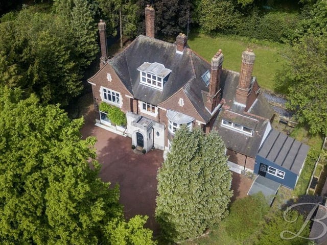 Before we step inside the Norfolk Drive mansion, let's take a look at an aerial shot from a drone. Private and secluded by mature trees, it sits on a plot spanning just under 0.6 acres.