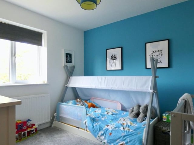 Like the second bedroom, the third is also currently set up for young children. A bright and compact corner of the house.
