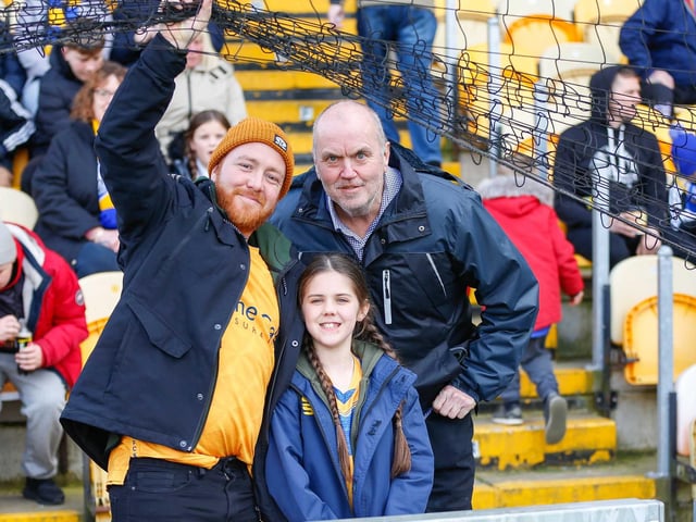 Mansfield Town fans watch the match against Northampton Town.