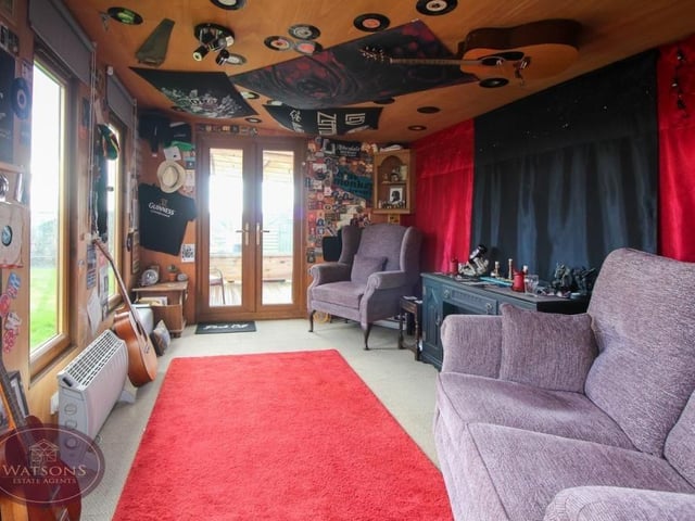 Let's move outside now, and into that stunning summer house, which sits in the back garden. Timber-built, it has power and more than enough room for any kind of furniture you fancy.