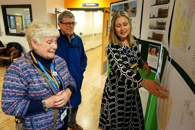 Amanda Barrett diagnostic improvement manager showing the plans to Sue Holmes governor Sherwood Forest hospitals and John Roddy a member of the public
