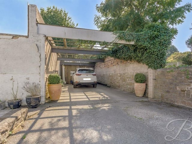 This car port leads to a garage at the £400,000 Kirkby bungalow.