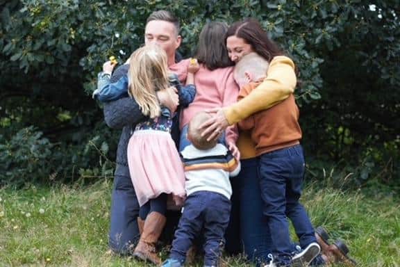A family hug for Victoria, John and their four children.