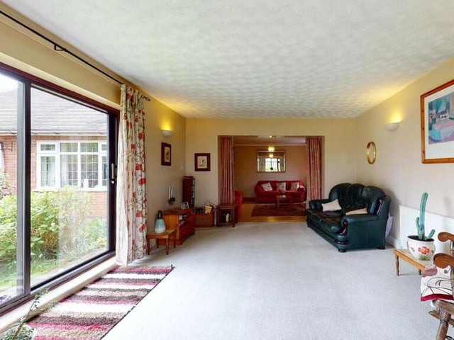 The sitting room features aluminium sliding patio doors that open out on to the wonderful garden at the £400,000-plus Nottingham Road property
