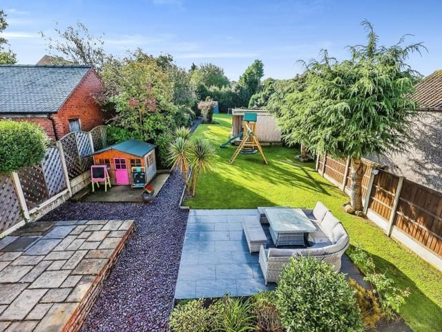A splendid view of the back garden and beyond from the Juliet balcony of the master bedroom. It underlines how extensive and well maintained the garden is, and the extent of the scenery on offer.
