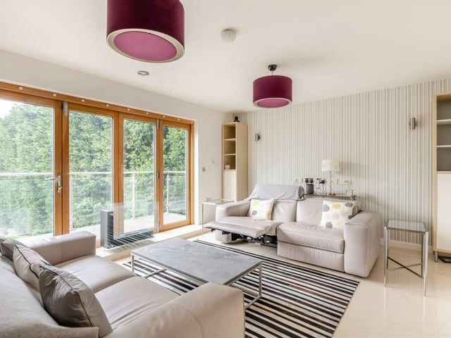 This lovely lounge area on the ground floor of the £700,000 property also provides access to the rear balcony.