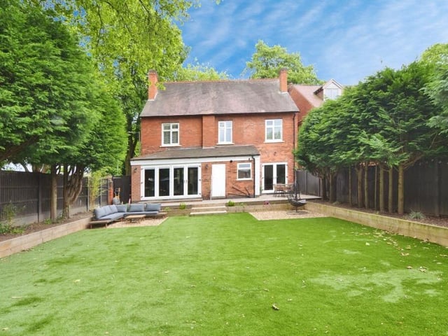 As we step outside, here is a view of the rear of the High Oakham Road property. The private garden has been fully landscaped and includes an artificial lawn, raised flowerbeds and well-established trees.