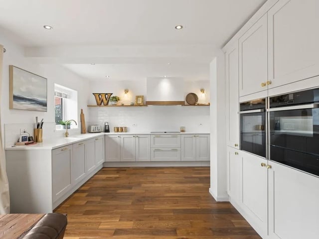 A spectacular bespoke kitchen beautifully designed and arranged with a multitude of sleek fitted cabinetry with full banks of larder and base units provides copious amounts of storage to keep everything organised. Top-quality Quartz worktops compliment the smart finish with inset sink and drainer. High-end Neff integrated appliances are showcased. The open-plan layout of the kitchen flows effortlessly into the dining area.