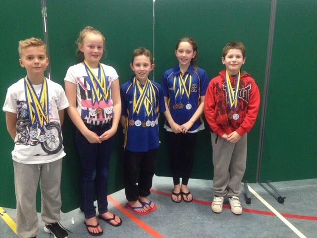 Five youngsters from Mansfield Swimming Club show off a haul of medals.