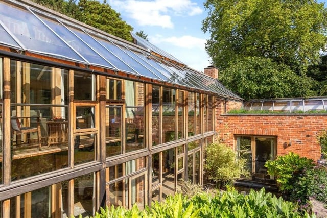 A view from outside of the £1.65 million house's energy-efficiency hub, the conservatory, complete with its balcony overlooking part of the garden.