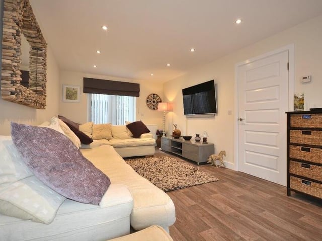 The attractive lounge also has French doors that lead out to the back garden.