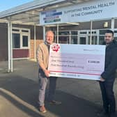 Councillor Kane Oliver presents the cheque for £1,500 to Paul Walsh, business development manager at Mental Health in the Community.