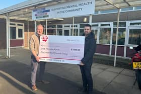 Councillor Kane Oliver presents the cheque for £1,500 to Paul Walsh, business development manager at Mental Health in the Community.