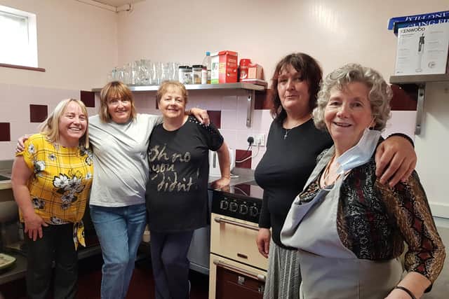 Volunteers are all smiles in the kitchen with new additions for cooking on-site.