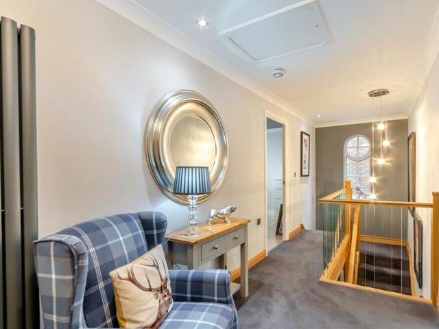 At the top of the stairs, you can't help but admire the galleried landing, especially its feature window. There is a built-in storage cupboard with ample shelving, plus a separate airing cupboard that houses a hot-water cylinder.
