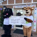 Stanley Stag, Mansfield Building Society's mascot, right, hands over the money to George the Dog, his equivalent at Bluebell Wood Children's Hospital.