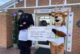 Stanley Stag, Mansfield Building Society's mascot, right, hands over the money to George the Dog, his equivalent at Bluebell Wood Children's Hospital.