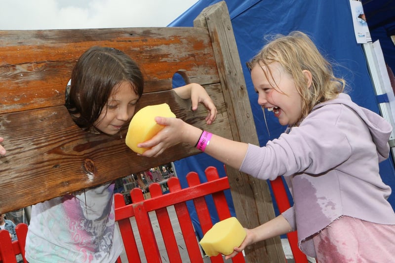 Julia Kowaclczyk and Freya Strouther took turns in the stocks for sponge-throwing fun.