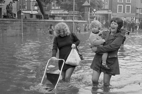 Shoppers made their way through flooded water on Bridge Street - July, 1973.