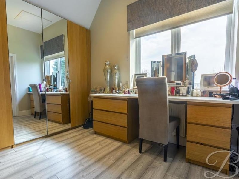 A close-up of the dressing-table area and wardrobes, which are part of the master bedroom.