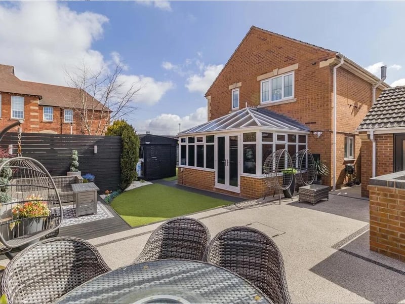 To the rear of the property, there is a delightful garden featuring a summerhouse, artificial lawn, decked patio, ample resin patio and a brick built bin storage area.
