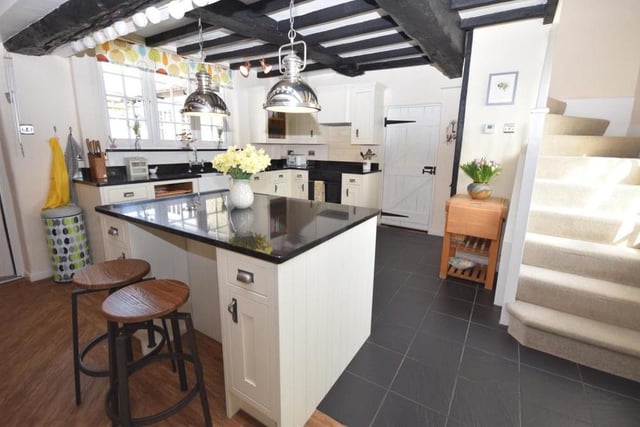 A fourth image of the dining kitchen and its array of home comforts. Other features include a farmhouse-style Belfast sink with mixer tap and granite splashback, a high-quality tiled floor and extra storage under the stairs.