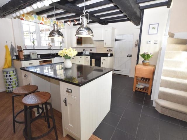 A fourth image of the dining kitchen and its array of home comforts. Other features include a farmhouse-style Belfast sink with mixer tap and granite splashback, a high-quality tiled floor and extra storage under the stairs.