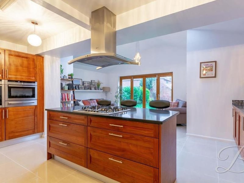Moving now into the sleek kitchen, which comes complete with matching units and cabinets. A range of integrated appliances includes an oven, hob, microwave, dishwasher and washer/dryer.