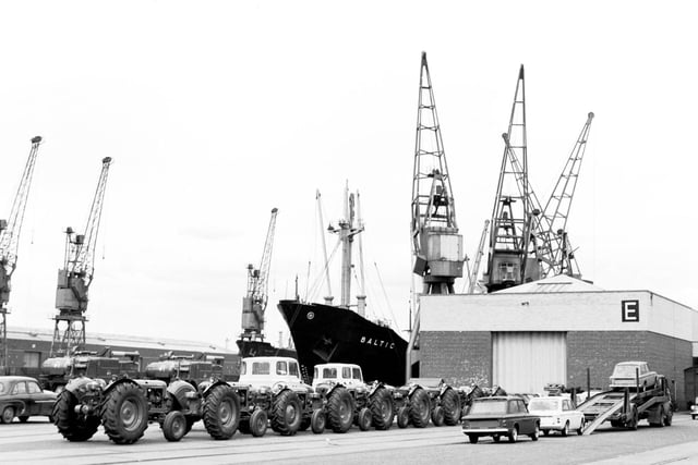 Tractors and cars ready to be loaded onto ship for export at Grangemouth docks in June 1966.