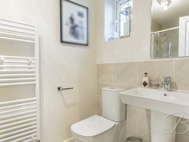 Like the main bedroom, the second bedroom also benefits from an en suite shower room that includes a shower cubicle, wash basin and WC.