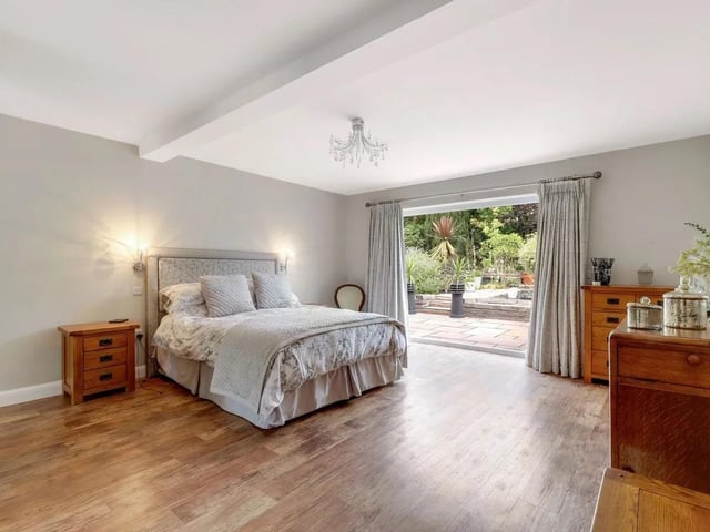 The spacious main bedroom features attractive wood flooring with under-floor heating and benefits from bi-folding doors, which open directly onto the rear garden and provide an abundance of natural light and fitted wardrobes. The room also benefits from convenient access to a private en suite creating a comfortable and practical principal bedroom suite.