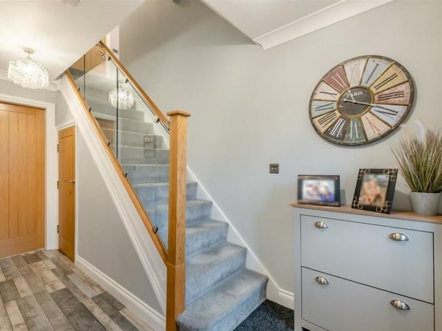 Let's check out the first floor now, which means passing through the entrance hall, where there is an under-stairs storage cupboard, and climbing the attractive oak staircase.