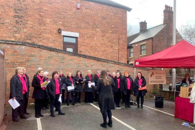 The Charlotte Mendley Community Choir performing in James Street car park during the festival.
