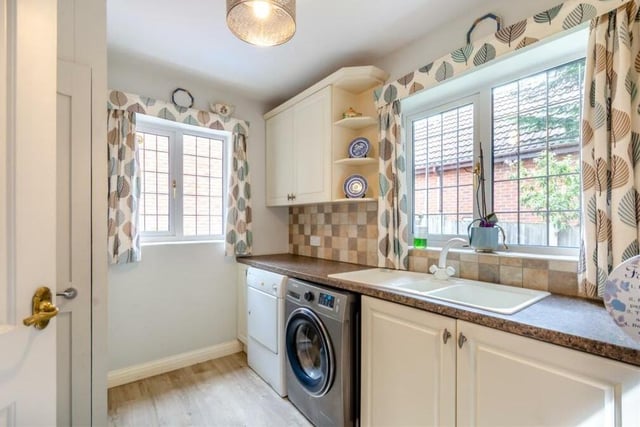 Just off the kitchen is this utility room, which includes wall and base units, work surfaces and an inset one-and-a-half bowl sink with drainer and mixer tap. There is space for a washing machine, while a built-in cupboard houses the Baxi gas-fired central heating boiler.