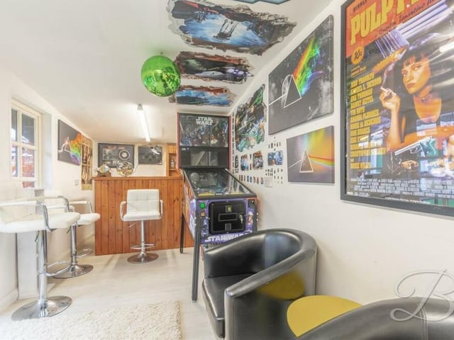 Take a look inside the exceptional bar. It is a perfect place to entertain family and friends, with room for seating and even a 'Star Wars' arcade machine!