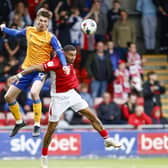Mansfield Town defender Oli Hawkins heads clear during the win at Crewe. Photo: Chris Holloway/The Bigger Picture.media.