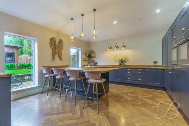 The stylish kitchen is equipped with an extensive range of shaker-style wall and base units, with complementary worktops over, and an inset sink and drainer with mixer tap. There is also a central island and breakfast bar.