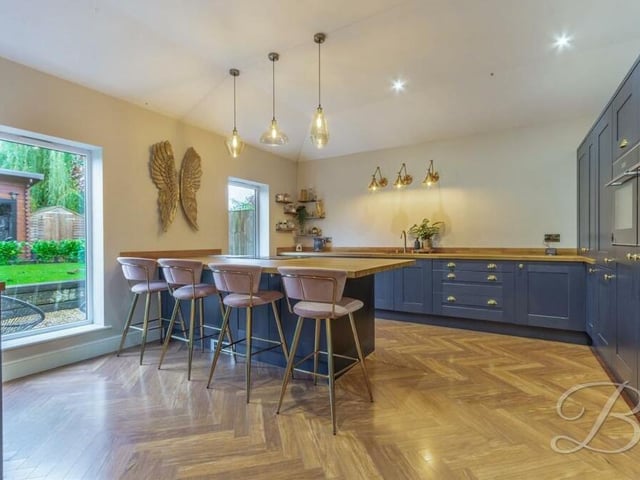 The stylish kitchen is equipped with an extensive range of shaker-style wall and base units, with complementary worktops over, and an inset sink and drainer with mixer tap. There is also a central island and breakfast bar.