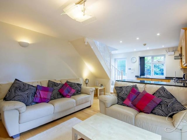 By the kitchen on the ground floor of the annexe is this comfortable living room, with space for dining.