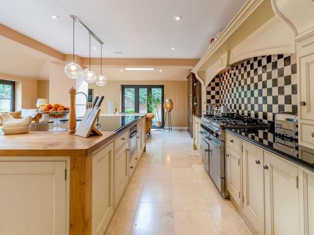 The stunning, bespoke fitted kitchen is by Osborne Of Ilkeston, with a range of hand-made shaker cabinets, complemented by antique silver doorknobs and black granite work surfaces. Integrated appliances include a large Falcon range cooker with two ovens, a separate grill, a warming drawer, a five-ring gas hob and built-in extractor hood. There is also a dishwasher and an integrated Neff microwave.