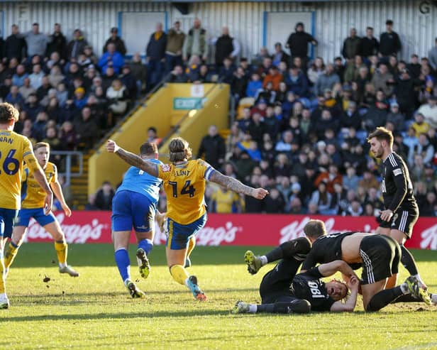 Mansfield Town defender Aden Flint in the thick of the action against Salford City on Saturday. Photo by Chris & Jeanette Holloway/The Bigger Picture.media