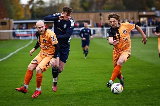 Keiran Coupe and Mikey Williams battle for possession.