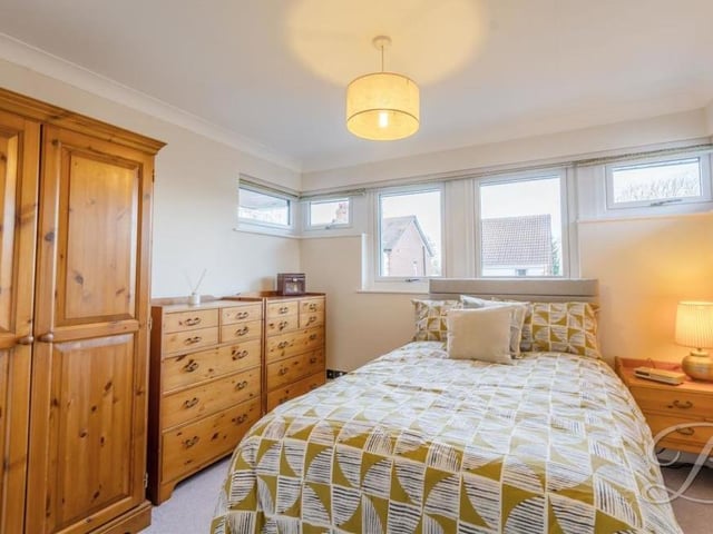 A wealth of natural light flows through the third bedroom thanks to triple-glazed windows. Features include a carpeted floor, coving to the ceiling and an abundance of space for storage.