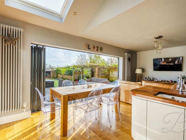 Fitted with a sky light allowing for ample natural light to flood through and bi-folding doors leading outside for added convenience.