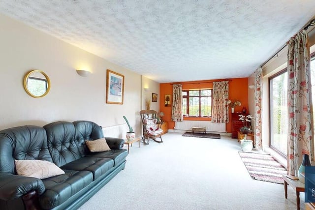 Next to the lounge is this large sitting room or family room. The bay window offers delightful, far-reaching views of the garden and open fields that adjoin the bungalow.