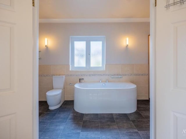 And here is that en suite bathroom, complete with a standalone bath and also a shower.