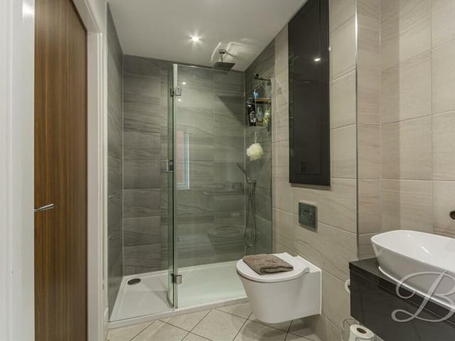 More en suite excellence on the first floor. A three-piece suite comprises a shower enclosure, two hand wash basins and a low-flush WC.